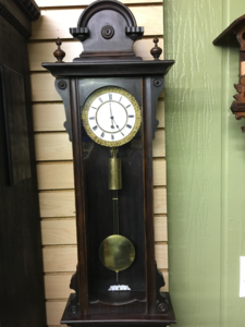Restored ornate Vienna regulator with a carved crest and turned finials
