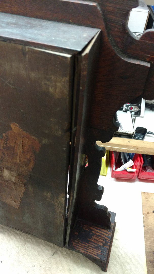 An antique oak clock case as it arrived at the shop — split along the seam, finish worn, old glue failing